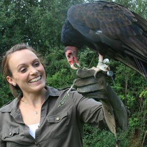 smiling woman holding vulture