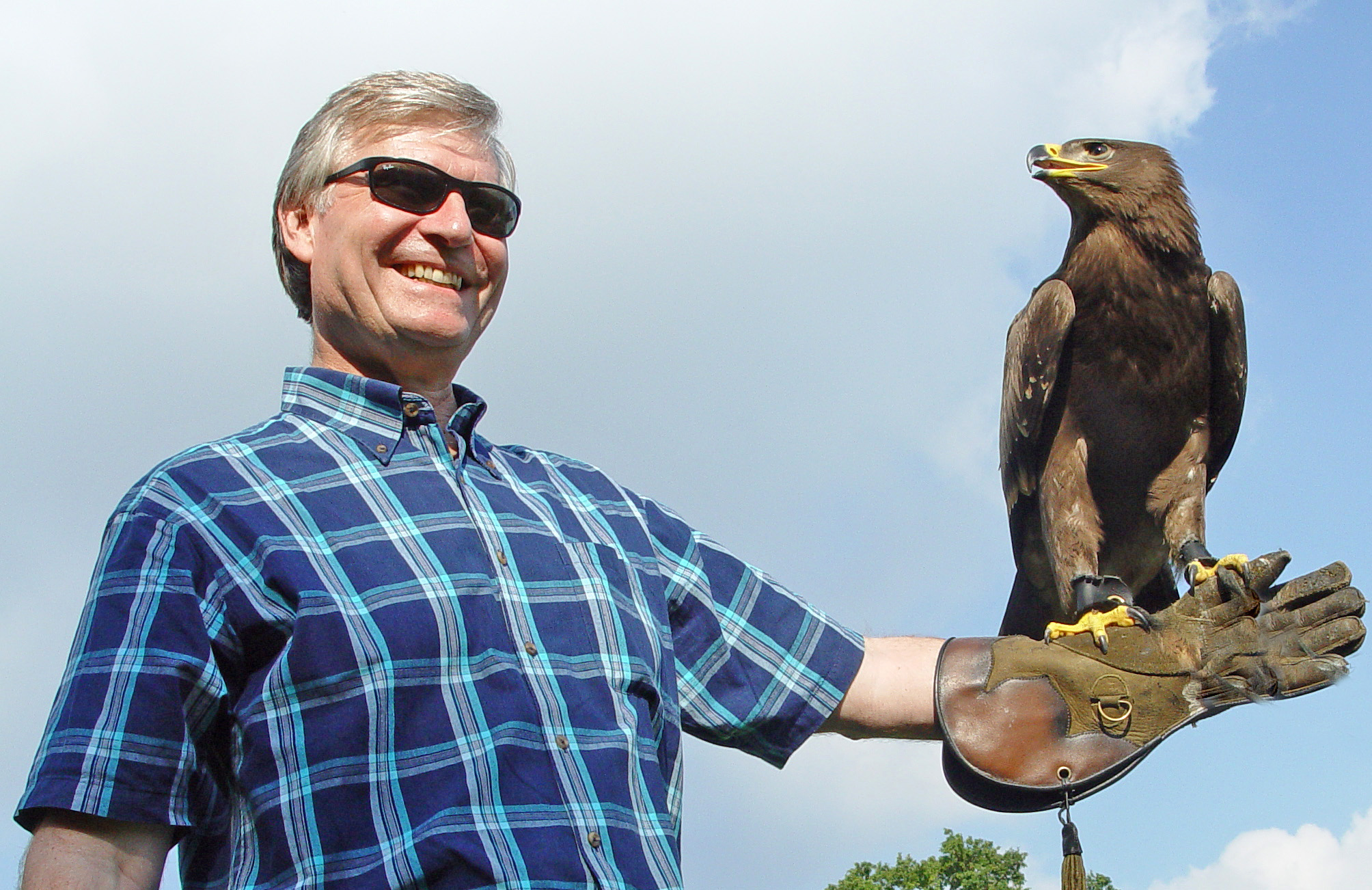 Smiling man holding eagle